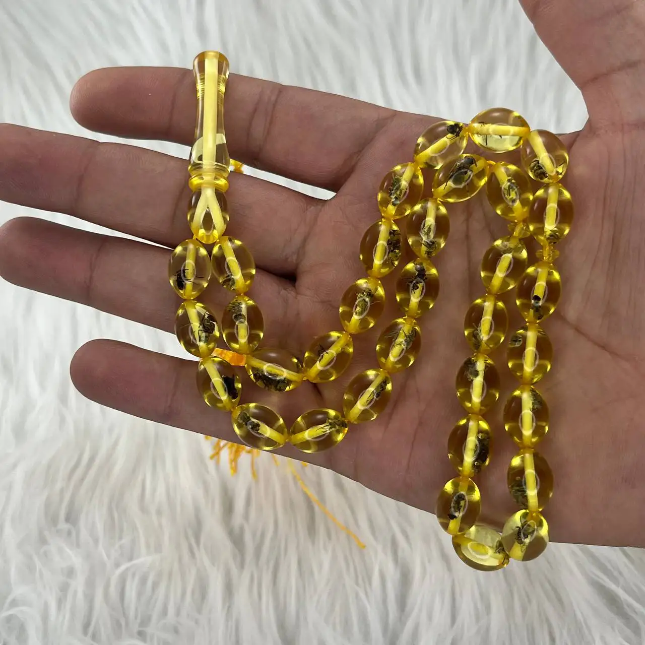 تسبیح پودر کهربا 33 دانه حشره دار زرد کدTA4 2 تسبیح پودر کهربا 33 دانه حشره دار زرد.2